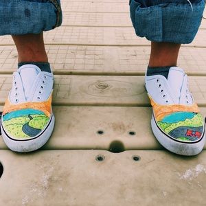 Flat white canvas sneakers with a lil art on em